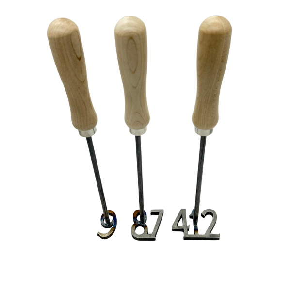 Three branding irons with wooden handles and metal branding tips, arranged vertically on a plain background.