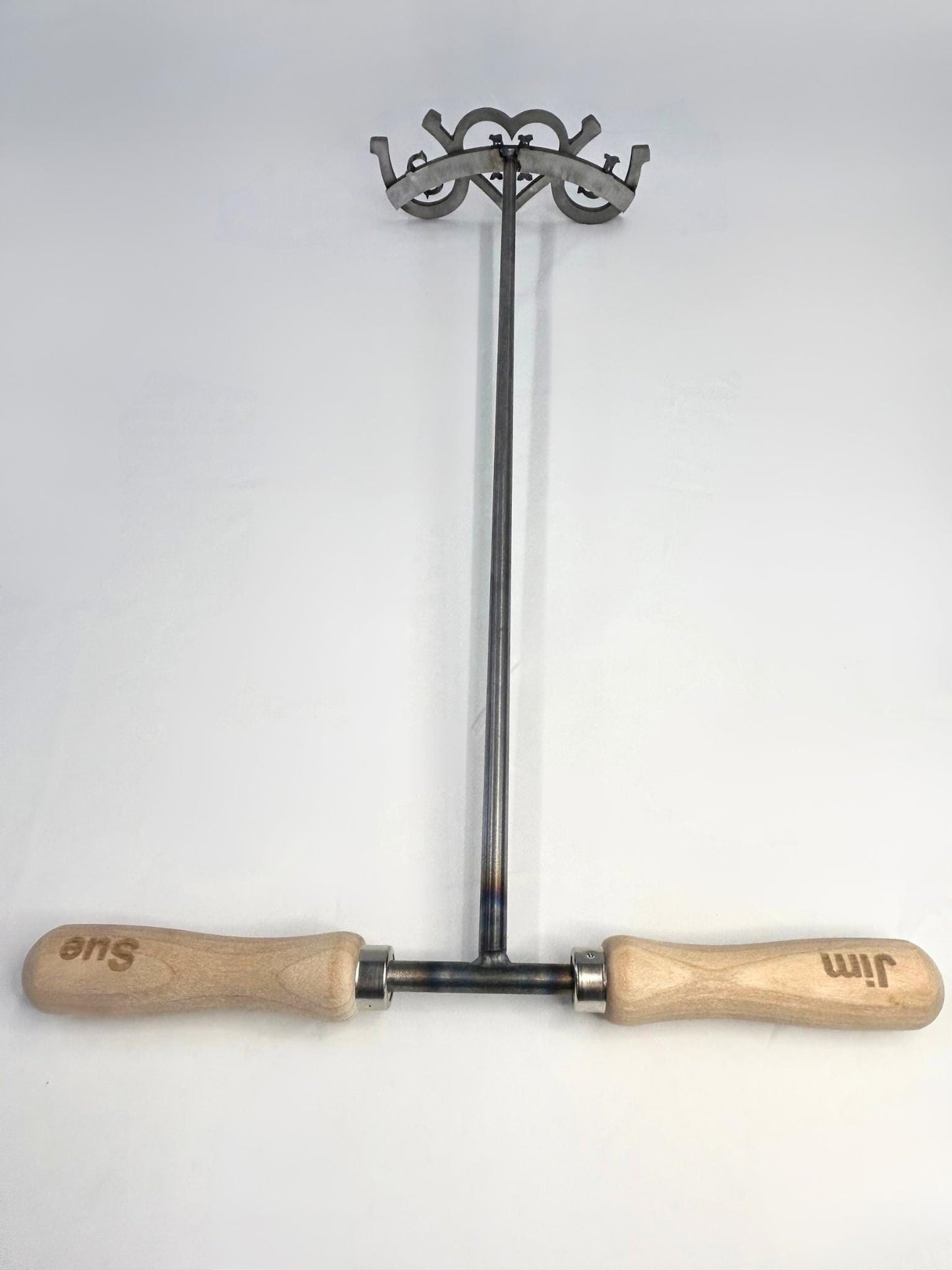 Full picture of wedding brander.Shows the engraved handles with bride and groom names, 24 rod coming downto the brand.