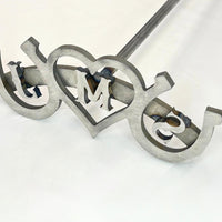 Three letter wedding branding iron with horseshoes on both sides and a heart in the middle. The letters are centered within heart and both horseshoes.