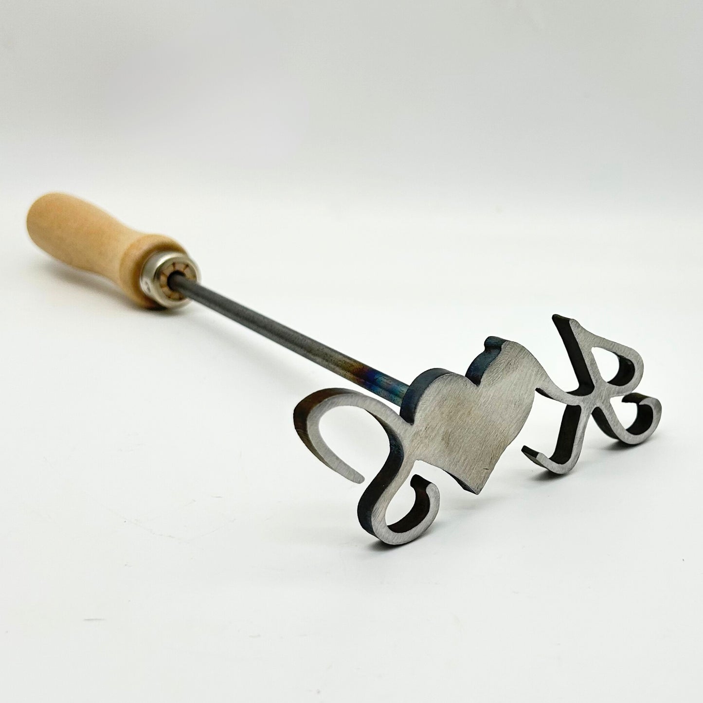 Close-up of personalized heart and initial branding iron.