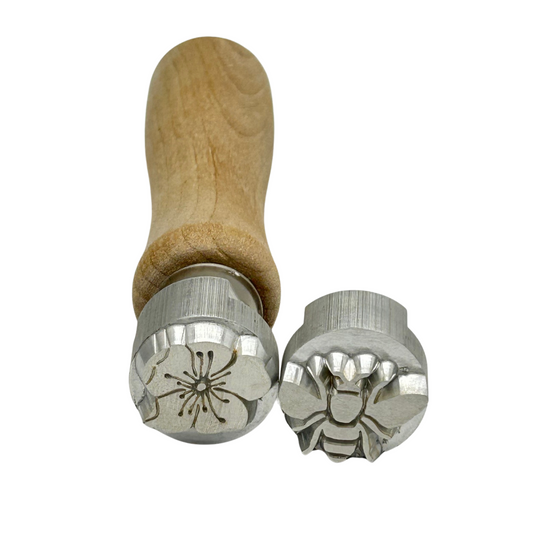 Pottery Stamps close up view of bee and cherry blossom