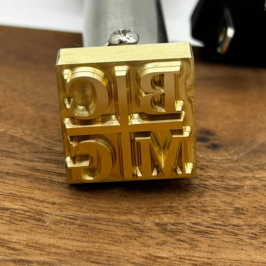 brass branding iron head zoomed in shot.