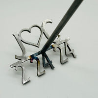 Displays the branding iron length at 6 inches The height is 24 inches. Close up of the brand, double handle for bride and groom as well as the engraved text on the each handle of bride and groom names.