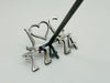 Displays the branding iron length at 6 inches The height is 24 inches. Close up of the brand, double handle for bride and groom as well as the engraved text on the each handle of bride and groom names.
